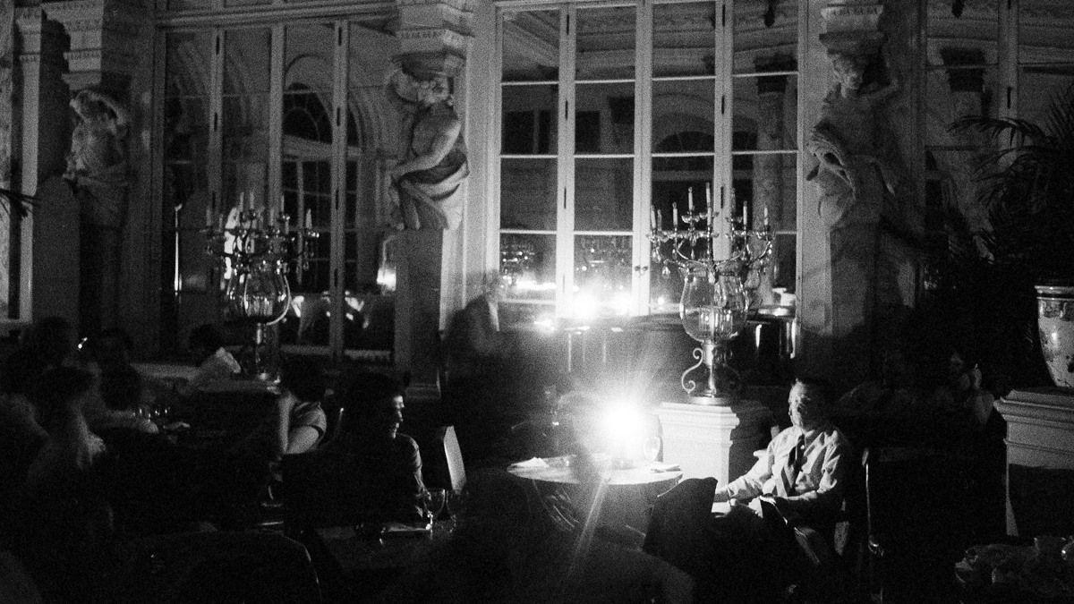Diners at the Palm Court in the Plaza Hotel in Manhattan dine by candlelight after a blackout hit New York City, July 13, 1977. The restaurant continued its business despite the power outage. (AP Photo/Calvin C. Cook)