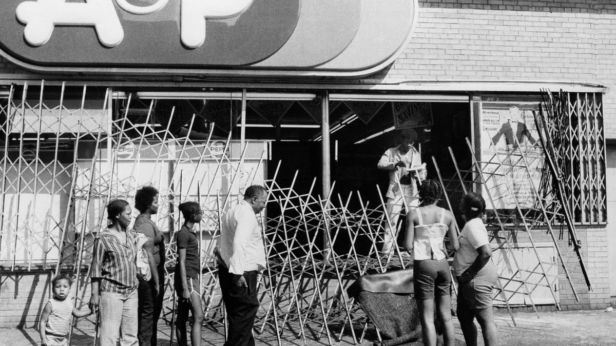 An A&P store with a destroyed front gate at 2298 Eighth Ave. at 124th St. Harlem is seen during the power failure in New York, July 13, 1977. (AP Photo)