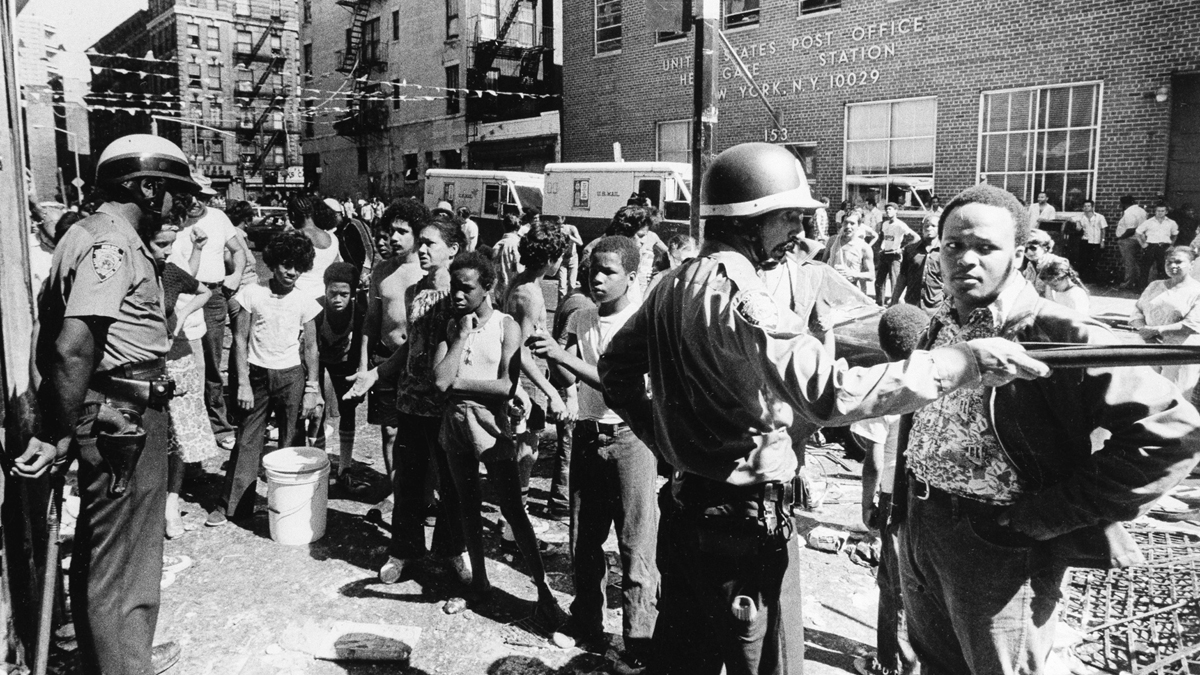 Police control a crowd on a street in Harlem in the aftermath of a power outage in New York City, July 14, 1977. (AP Photo)