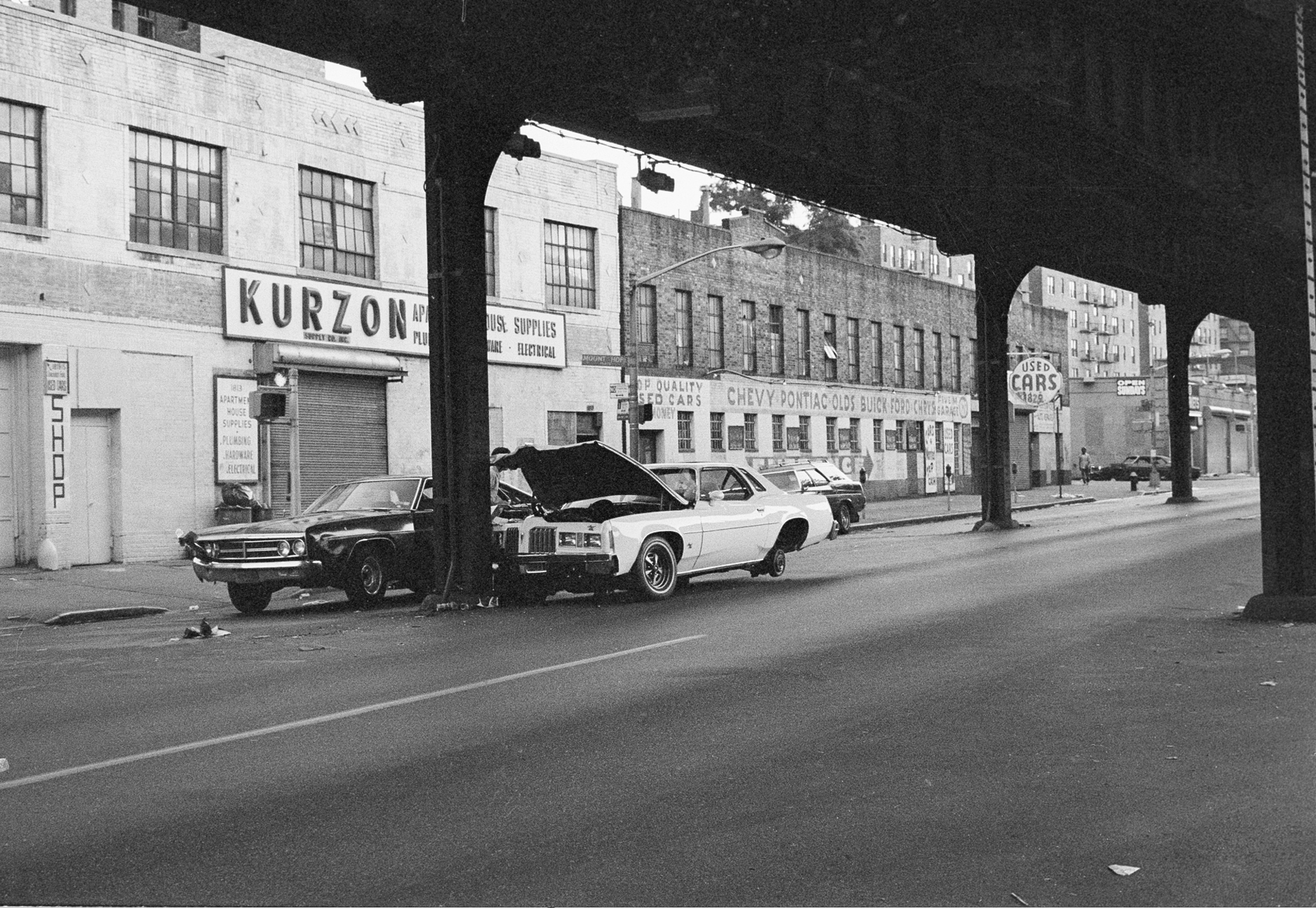 New cars stripped of parts are left on the street outside a car dealer in the New York borough of the Bronx, early Thursday, July 14, 1977. Looters pushed the car out of the show room and stripped them in the street. (AP Photo)