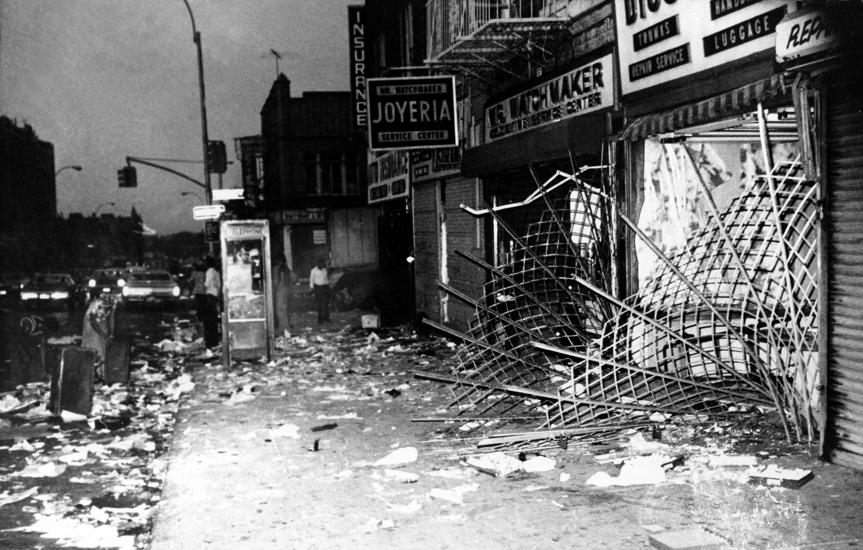This is a scene along Utica Ave., in Brooklyn during New York City's electrical power outage on Thursday, July 14, 1977. In one three-block length virtually every store had its windows smashed and its contents looted in the aftermath of the blackout July 13. (AP Photo)