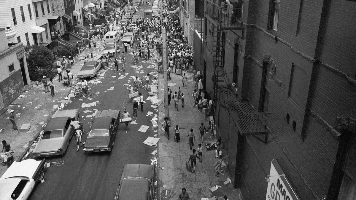 A street in the Bedford-Stuyvesant section of Brooklyn is full of people and debris, July 14, 1977 following the massive blackout in New York City. (AP Photo)