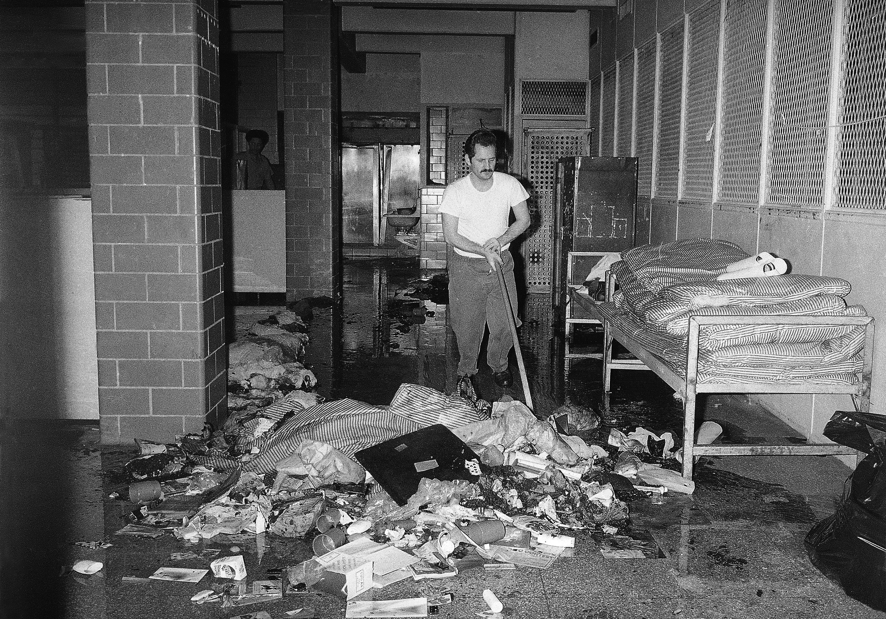 An inmate cleans up mess at the Bronx House of Detention in New York on Thursday, July 14, 1977. Corrections officials said inmates caused damage in three dormitories during the electric power failure that struck New York.