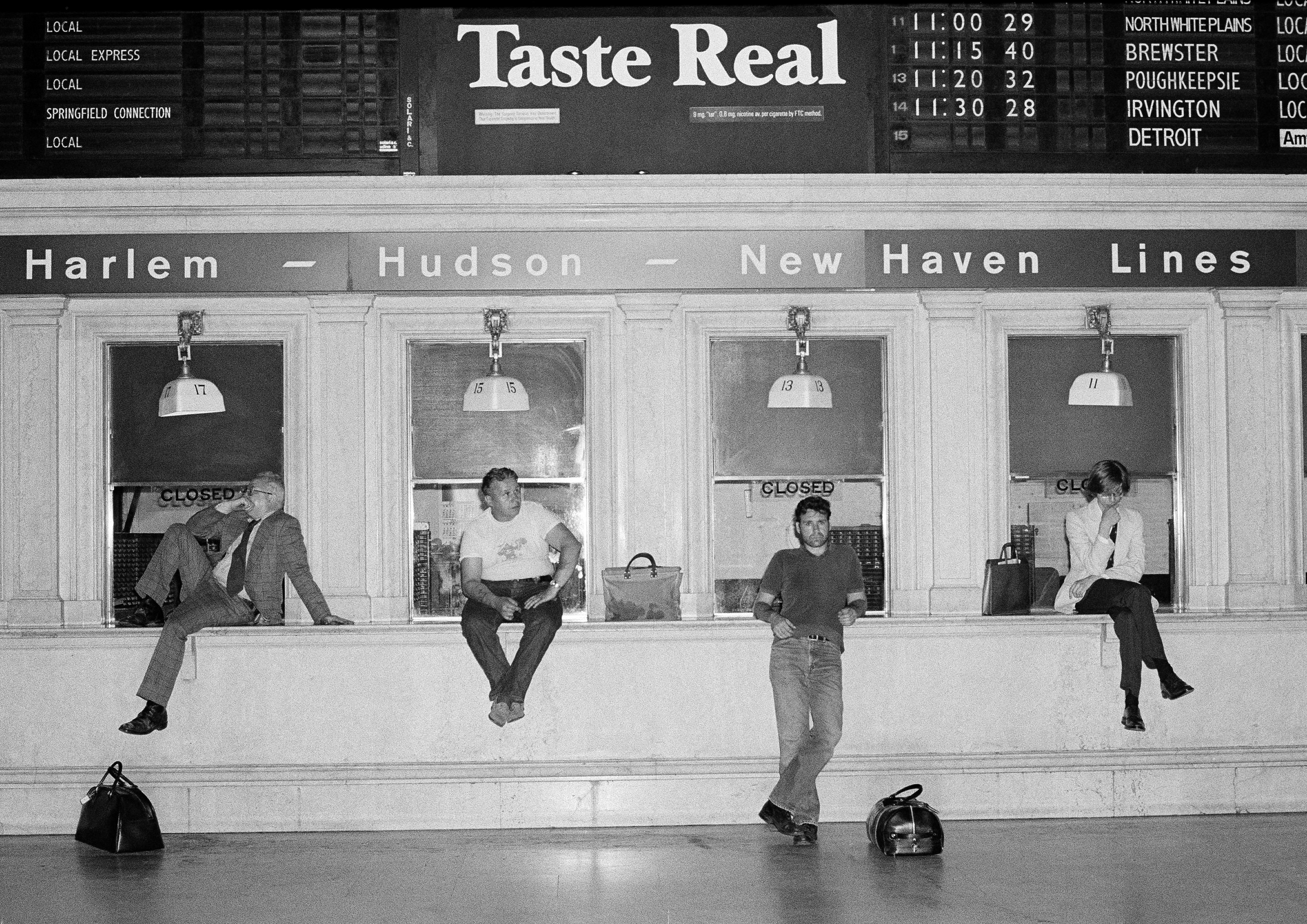 Commuters wait at empty ticket windows at Grand Central Station in New York City, early on July 14, 1977, as trains were canceled by the electric power failure that affected most public transportation in the city. (AP Photo/Carlos Rene Perez)