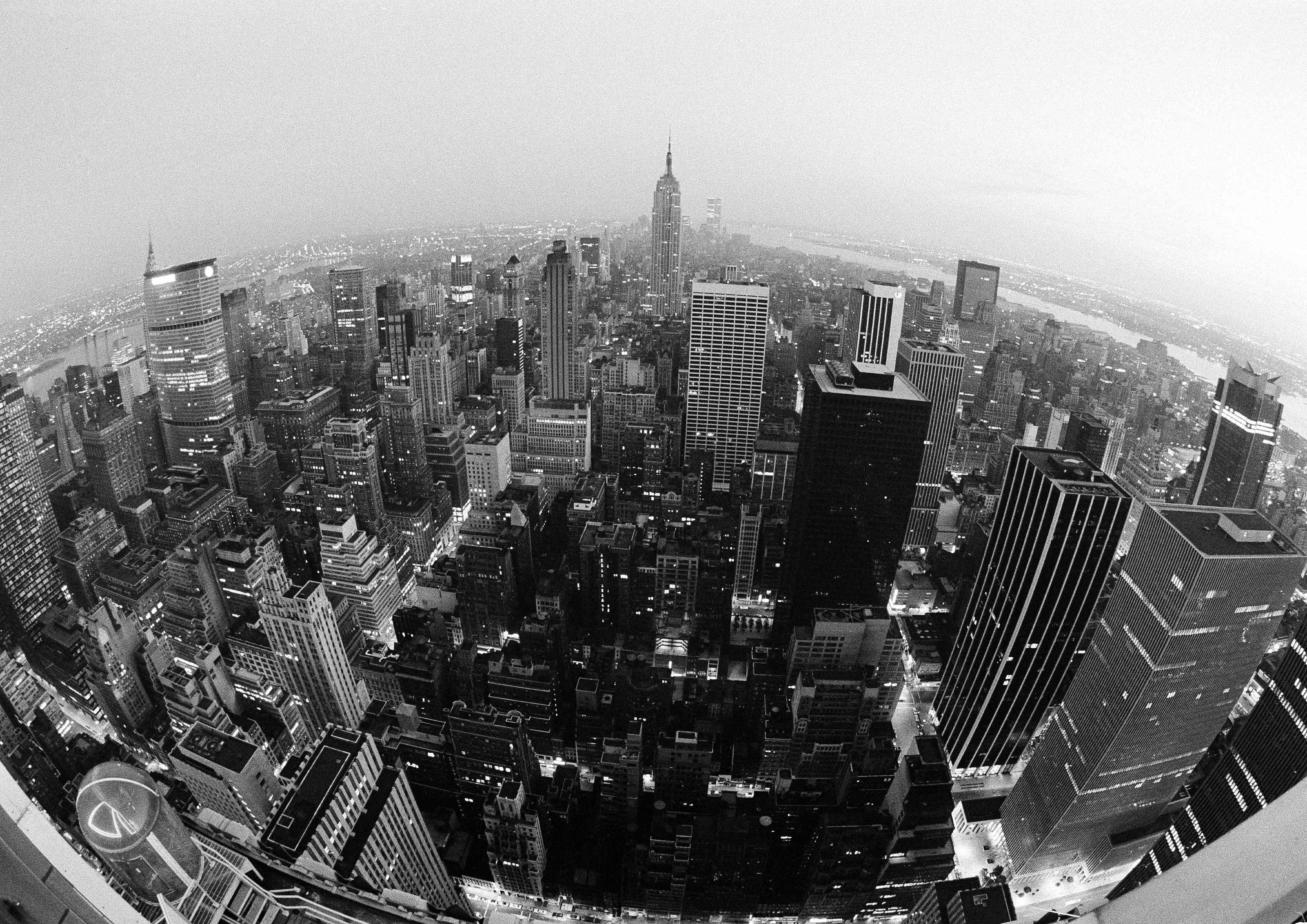 Much of New York twinkles with light after electricity was restored in many areas, July 14, 1977, nearly a day after the massive power failure. About 90 percent of the city had electricity again. A small portion of midtown, foreground, was still waiting. Photo was made with a fisheye lens. (AP Photo/Ira Schwarz)