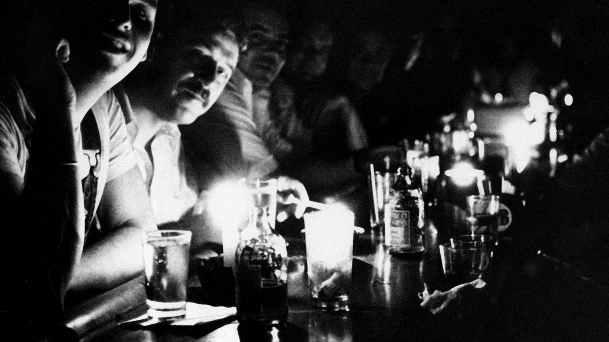 People at Chapman's Restaurant in midtown Manhattan continue their drinking by candlelight after New York City had a blackout, July 13, 1977. All of New York City and its boroughs were blacked out, as was much of the area surrounding the city. (AP Photo/Dave Pickoff)