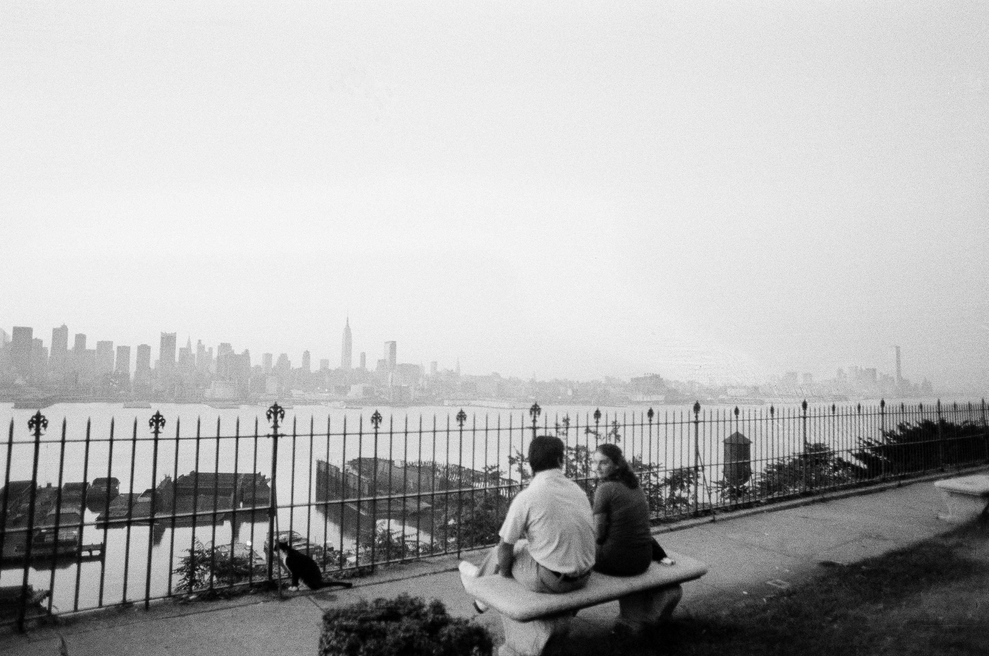 Early rising couple in West New York, N.J., have a different view of the New York skyline at sunrise - no city lights, July 14, 1977. (AP Photo/Sandy Colton)
