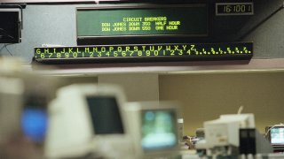 A electronic message board on the floor of the Pacific Exchange displays the mandatory shut downs of Dow Jones Industrials, Monday, Oct. 27, 1997 in Los Angeles. The Dow Jones industrial average suffered its worst single-day point drop in history on Monday, plummeting more than 550 points before trading was automatically shut down for the rest of the day. A circuit breaker automatically halts trading on the New York Stock Exchange for half an hour when the Dow Jones Industrial Average drops by 350 points and again for an hour when the blue-chip indicator drops by 550 points. (AP Photo/Kevork Djansezian)