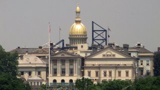 The New Jersey Statehouse in Trenton is seen from across the Delaware River in Morrisville, Pa.