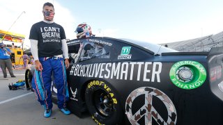 In this June 10, 2020, file photo, driver Bubba Wallace waits for the start of a NASCAR Cup Series auto race in Martinsville, Va.