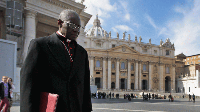 In this Monday, March 4, 2013 file photo, Cardinal Robert Sarah, of Guinea, walks in St. Peter’s Square after attending a cardinals’ meeting, at the Vatican.