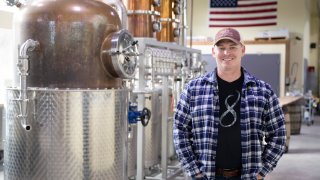 Chad Butters, founder of Eight Oaks Farm Distillery, poses for a photo at their facility in New Tripoli, Pa., Monday, March 16, 2020. Butters, who grew increasingly angry as he saw the skyrocketing price of hand sanitizer, has decided to do something about it: He's temporarily converting his operation into a production line for the suddenly hard-to-find, gooey, alcohol-based disinfectant.