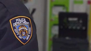 NYPD officer stands in frame