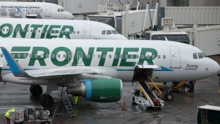 Frontier Airlines Inc. planes sit on the tarmac at Denver International Airport