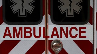 the back doors of an ambulance with the word ambulance emblazoned across the double doors