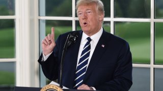 President Donald Trump gestures as he speaks during a dinner with business leaders in Bedminster, New Jersey, on Aug. 7, 2018.