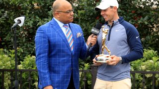 Rory McIlroy of Northern Ireland holds the new Players Championship trophy as he is interviewed by Mike Tirico after his one shot win as fans take photographs with their phones during the final round of The Players Championship on the Stadium Course at TPC Sawgrass on March 17, 2019 in Ponte Vedra Beach, Florida.