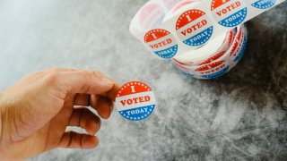 Cropped Hand Of Man Holding Sticker With Text At Table