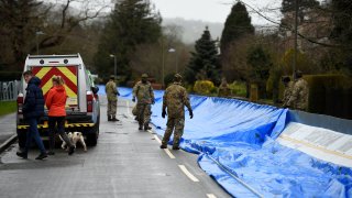 Members of the 4th Battalion Royal Regiment of Scotland erect a flood barrier in preparation for Storm Dennis