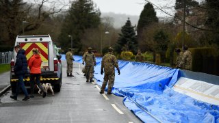 Members of the 4th Battalion Royal Regiment of Scotland erect a flood barrier in preparation for Storm Dennis