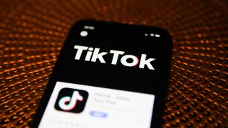 In this Feb. 20, 2020, file photo, the TikTok logo is seen displayed on a phone screen in Poland.