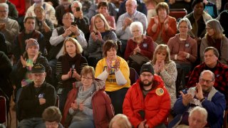 Audience members listen as Democratic presidential candidate former South Bend, Indiana, Mayor Pete Buttigieg speaks at a Get Out The Caucus rally Feb. 1, 2020, in Oelwein, Iowa. Iowa holds the state’s caucuses in two days, on Feb. 3.