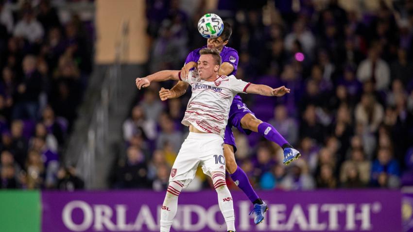 Orlando City midfielder João Moutinho (4) and Real Salt Lake forward Corey Baird (10) go up for a header during the soccer match between Real Salt Lake and Orlando City SC. on Feb. 29, 2020, at Exploria Stadium in Orlando Florida.