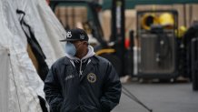 A member of the NYC Medical Examiners Office at the site as workers build a makeshift morgue outside of Bellevue Hospital to handle an expected surge in Coronavirus victims