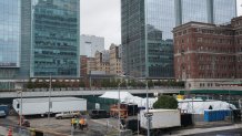 Workers build a makeshift morgue outside of Bellevue Hospital to handle an expected surge in Coronavirus victims on March 25, 2020 in New York. - President Donald Trump declared the beginning of the end of the coronavirus crisis in the United States on Tuesday and called for a quick end to social distancing, even as New York's governor compared the growing pandemic to a "bullet train." (Photo by Bryan R. Smith / AFP) (Photo by BRYAN R. SMITH/AFP via Getty Images)