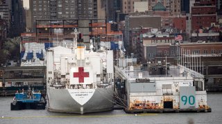 The USNS Comfort hospital ship is docked at Pier 90 in Manhattan on April 3, 2020 as seen from West New York, New Jersey.