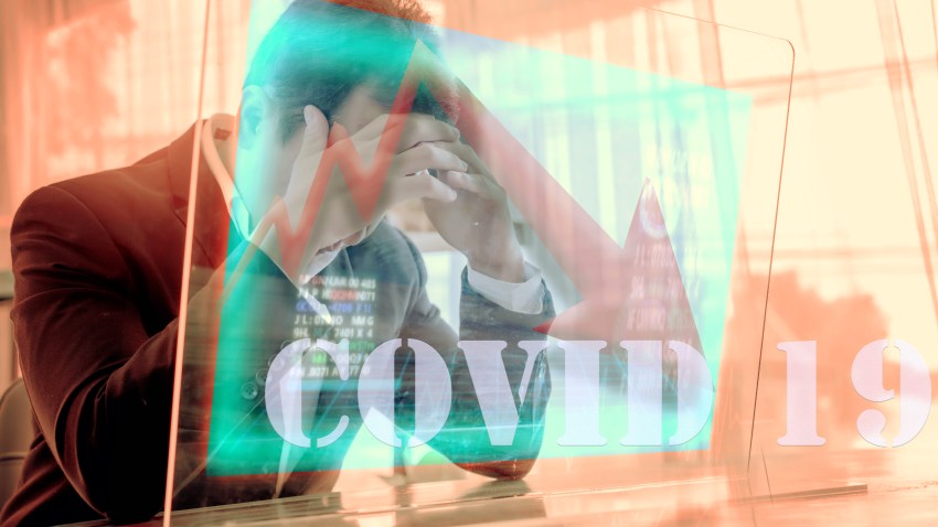 Concept of financial problems. Man holding his head while the markets plunge serious Covid-19 ,corona virus effect health investment