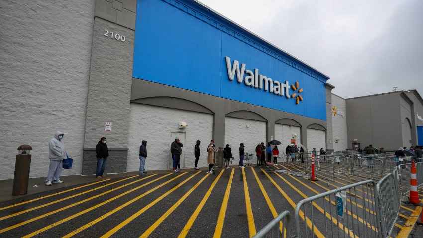 People line up outside a Walmart in New Jersey on April 18, 2020.