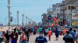 People enjoy the boardwalk during the Memorial Day holiday weekend amid the coronavirus pandemic on May 23, 2020 in Ocean City, Maryland