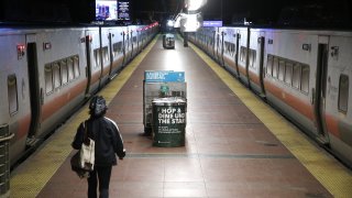 a woman walks to her train in grand central