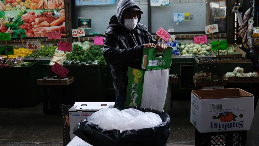 A grocery store worker recycles boxes in Brooklyn, March 28, 2020.