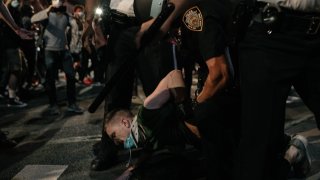 Protester arrested by NYPD officers