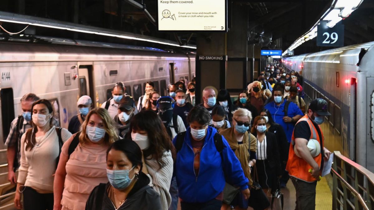 people in masks at new york city subway station