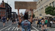 Protesters hold signs during the Queer Liberation March hosted by The Reclaim Pride Coalition for Trans and Queer black lives and against police brutality in lower Manhattan on June 28, 2020 in New York. (Photo by Bryan R. Smith / AFP) (Photo by BRYAN R. SMITH/AFP via Getty Images)