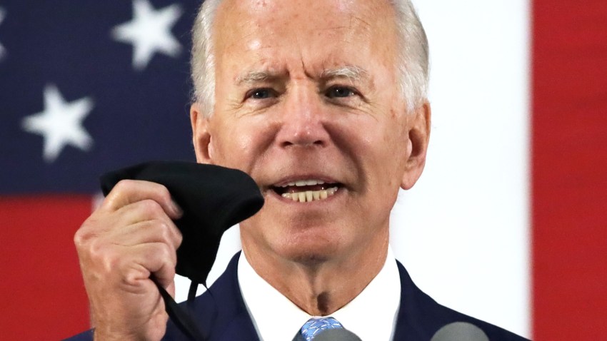 Democratic presidential candidate, former Vice President Joe Biden holds up a mask as he speaks during a campaign event June 30, 2020 at Alexis I. Dupont High School in Wilmington, Delaware. Biden discussed the Trump Administration’s handling of the COVID-19 pandemic. (