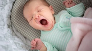 Newborn baby yawning.