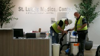 In this April 23, 2020, file photo, contract workers join the Army Corps of Engineers as they get the currently dormant St. Luke's Hospital ready for reopening in the case of a surge of coronavirus patients in Phoenix.
