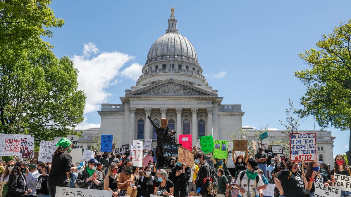 Crowds outside the Wisconsin State Capitol tore down two statues and attacked a state senator amid protests following the arrest of a Black man who wa