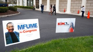 Kimberly Klacik, top center, the Republican candidate in the 7th Congressional District special election, walks with her security detail as she visits campaign supporters outside of a voting center, Tuesday, April 28, 2020, in Windsor Mill, Md. Klacik is going up against Democrat Kweisi Mfume in the election to fill a seat left open by the death last October of Congressman Elijah Cummings. An election that has been dramatically reshaped by the coronavirus outbreak.