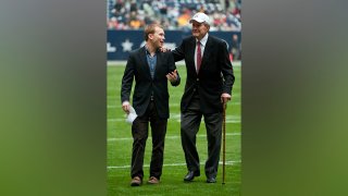 FILE - In this Dec. 31, 2009, file photo, late President George H. W. Bush, right, leaves the field alongside grandson Pierce Bush, left, before the Texas Bowl NCAA college football game in Houston. Pierce Bush announced Dec. 9, 2019, that he'll run in the Republican primary for a congressional seat near Houston.