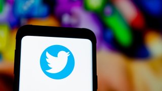 A Twitter logo seen displayed on a smartphone.