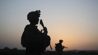 In this file photo, U.S. Marines with the 2nd Marine Expeditionary Brigade, RCT 2nd Battalion 8th Marines Echo Co. step off in the early morning during an operation to push out Taliban fighters on July 18, 2009 in Herati, Afghanistan.
