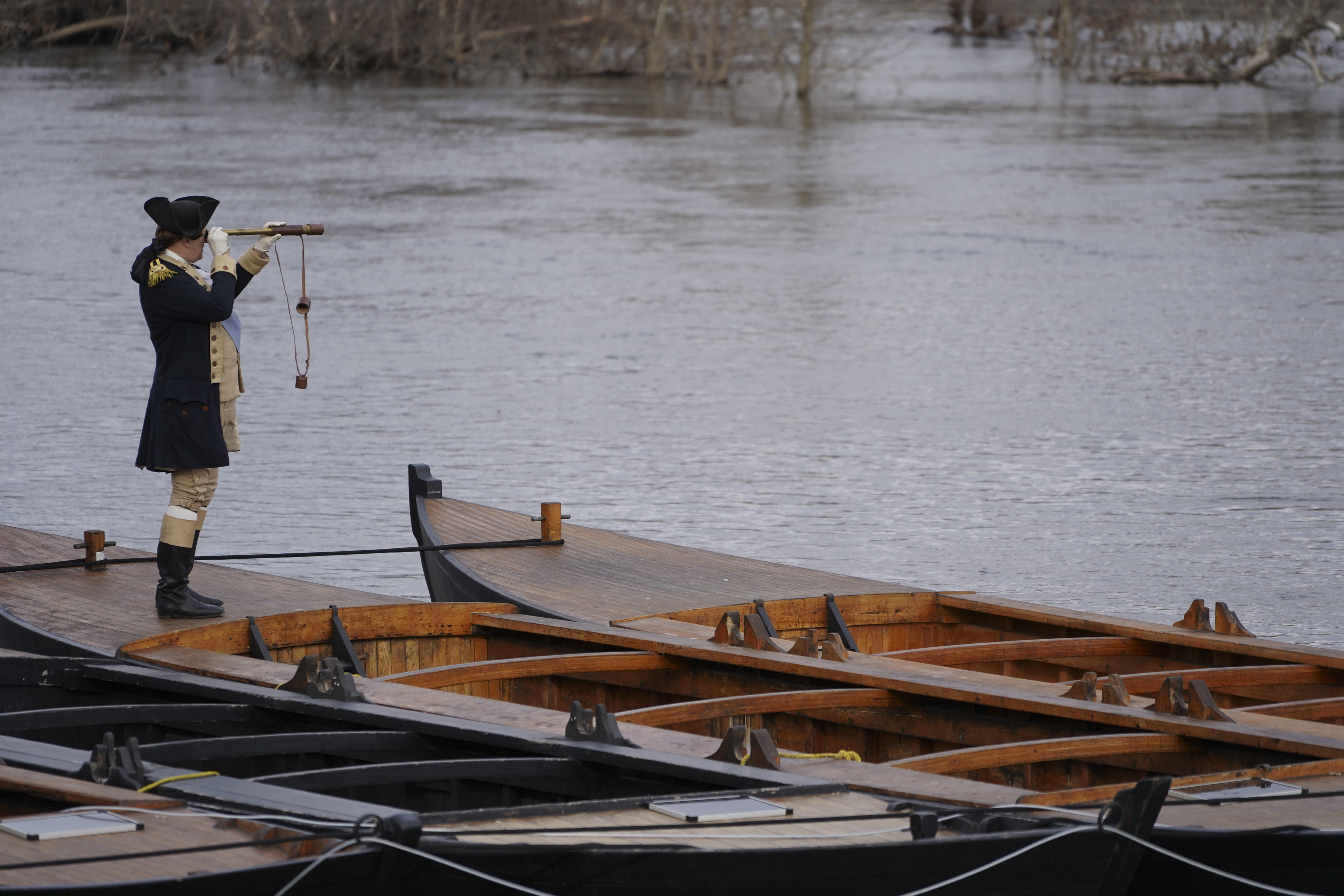 A Revolutionary war re-enactor portraying Gen. George Washington looks across the river towards New Jersey during the 66th annual re-enactment of Washington crossing the Delaware River, Dec. 25, 2018, in Upper Makefield, Pa. High water levels prevented the re-enactors from rowing their Durham boats across the river.