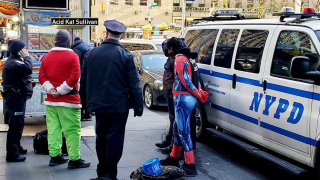 Costumed characters are under NYPD custody for allegedly forming a human wall at Rockefeller Center.