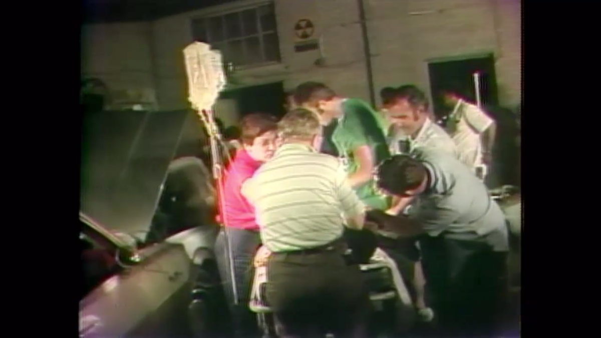 A doctor uses a car battery to perform surgery during the blackout.