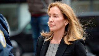 Felicity Huffman escorted by police into court